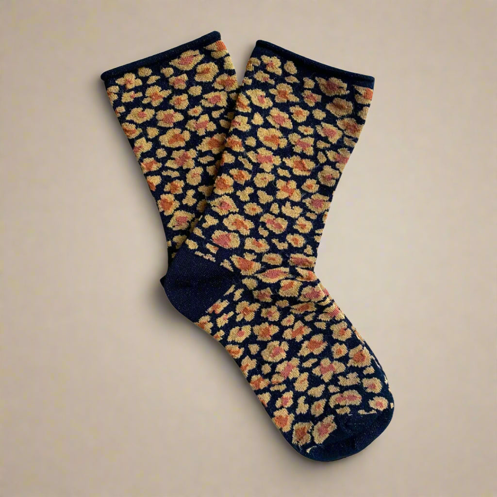 KLUE eco-friendly amber leopard socks styled with jeans and black leather shoes