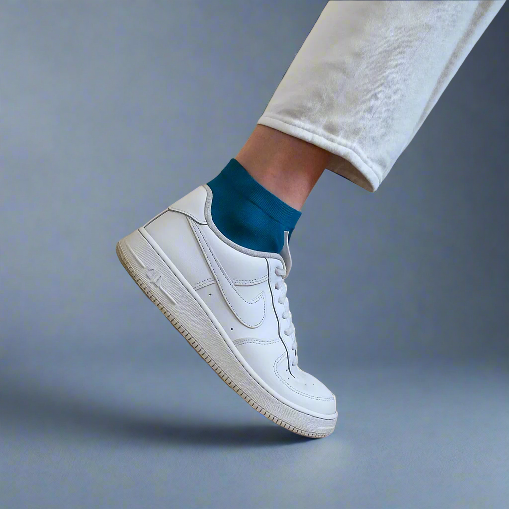Women's bright turquoise lyocell ankle socks worn with white sneakers and cropped pants – Klue bold sustainable socks style