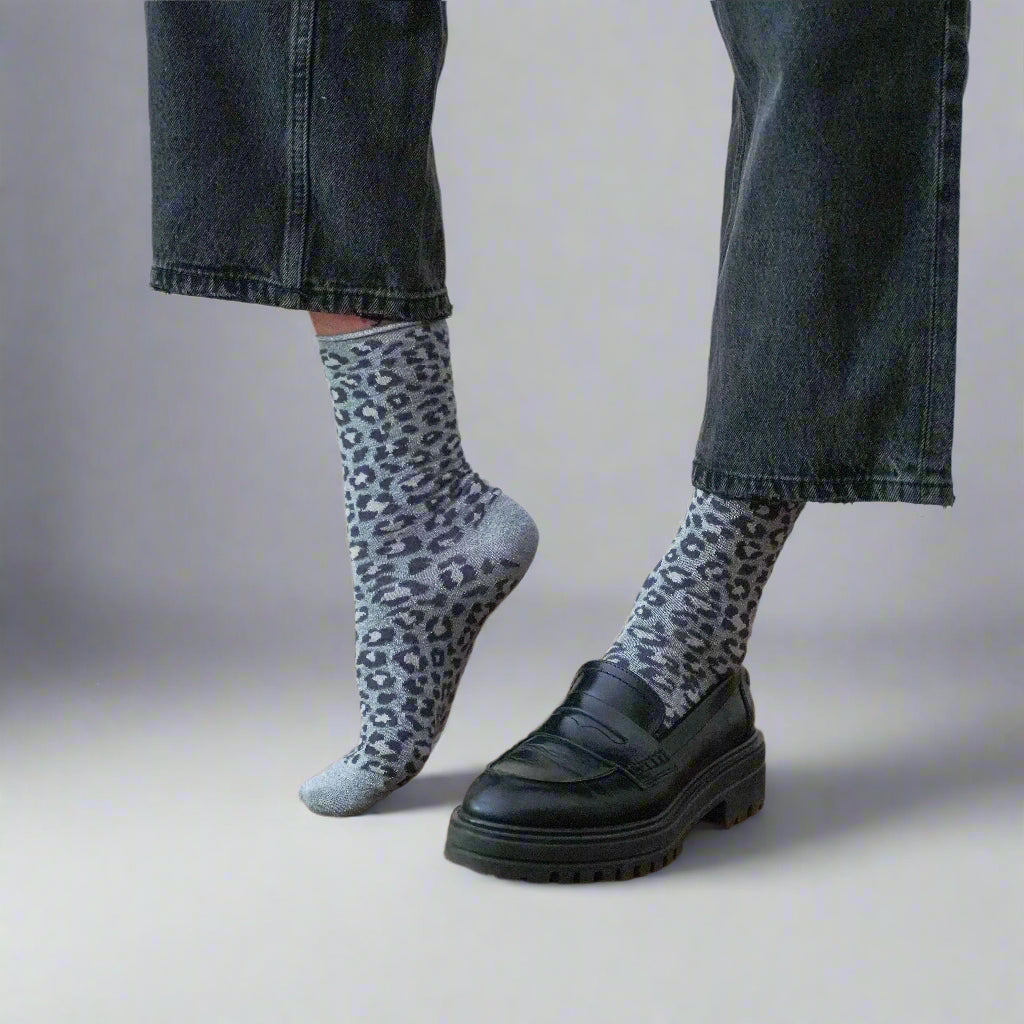 KLUE eco-friendly grey leopard socks styled with jeans and black leather shoes
