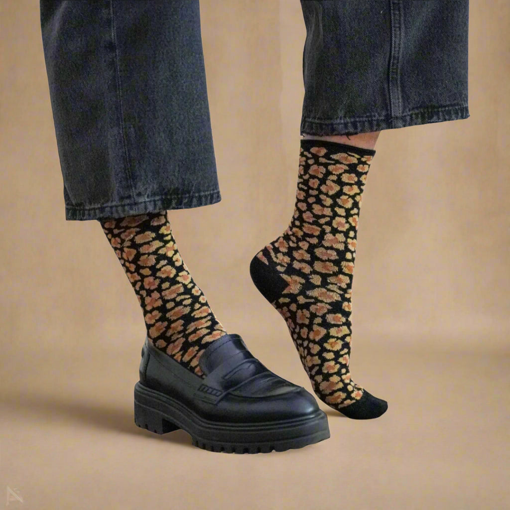 KLUE eco-friendly amber leopard socks styled with jeans and black leather shoes