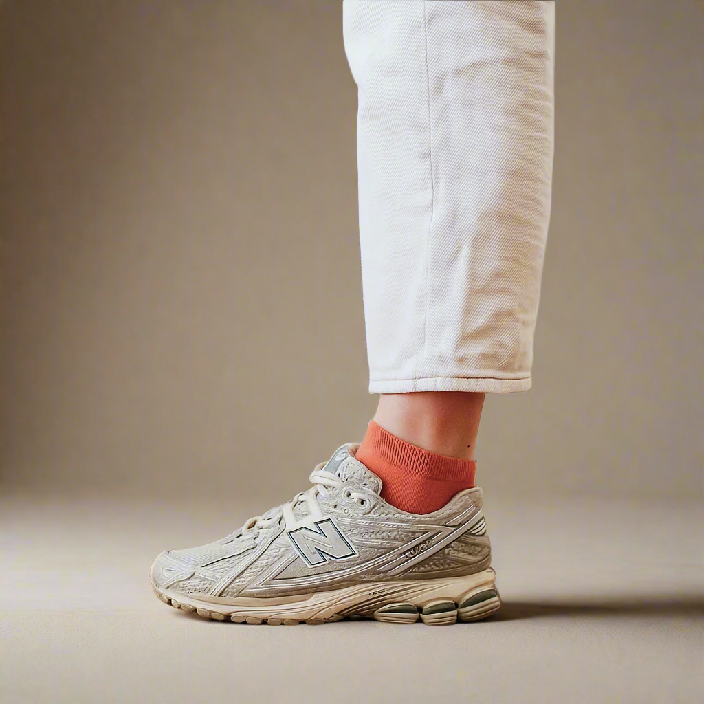 Women's terracotta lyocell low socks worn with white sneakers and neutral pants – Klue earthy sustainable socks style.
