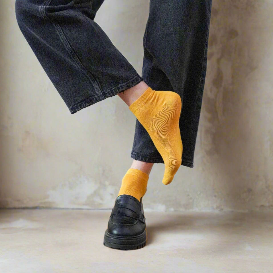 Women's yellow lyocell low socks worn with white sneakers and light trousers – Klue bright sustainable fashion look.